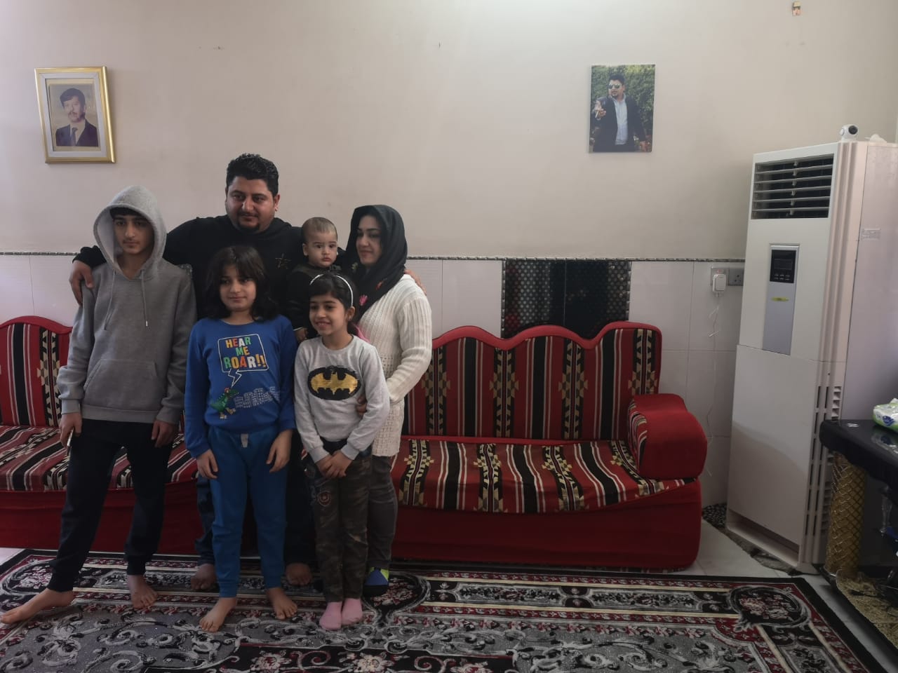 Hassanein Mohsen, his wife Nour and their four children in their home in Karbala. Hassanein is desperate to leave Iraq, where he says corruption has worn down public services so much that his homeland is no longer a safe place to raise his children.