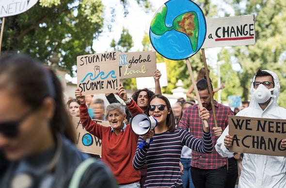 Demonstrators carry banners and loudspeakers in a global strike related to climate change issues. Credit: Getty Images